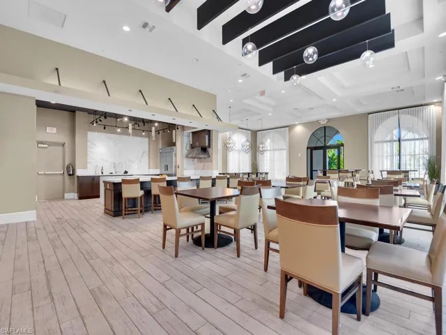 Dining area with coffered ceiling and light wood finished floors