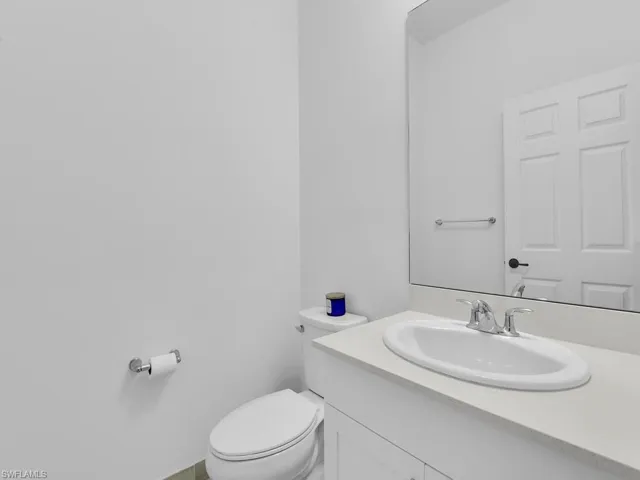 Half bath with vanity and toilet