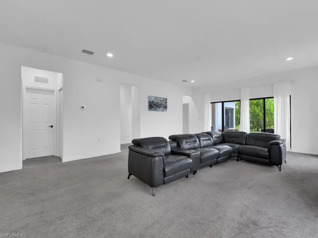 Living room featuring carpet and recessed lighting