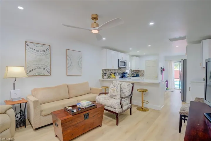 Living area featuring light wood finished floors, recessed lighting, and ceiling fan