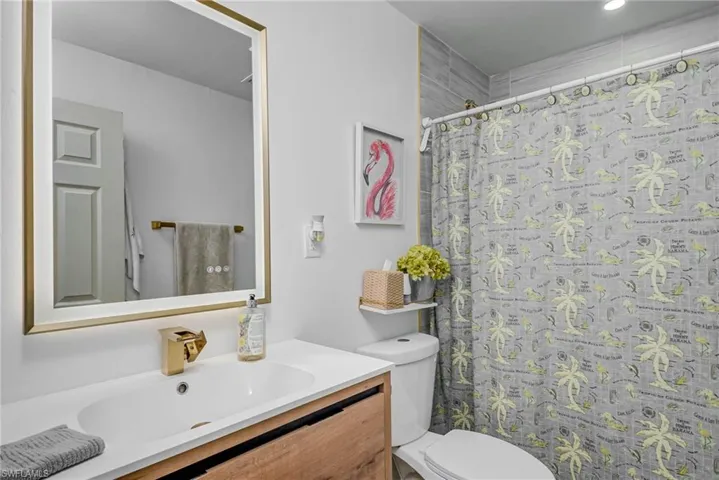 Full bathroom with vanity and curtained shower