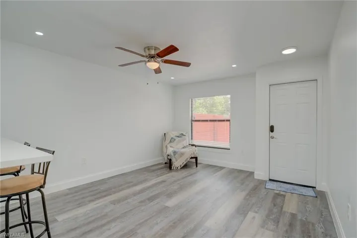 Unfurnished room with wood finished floors, a ceiling fan, and recessed lighting