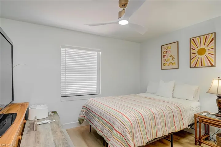 Bedroom featuring wood finished floors and a ceiling fan