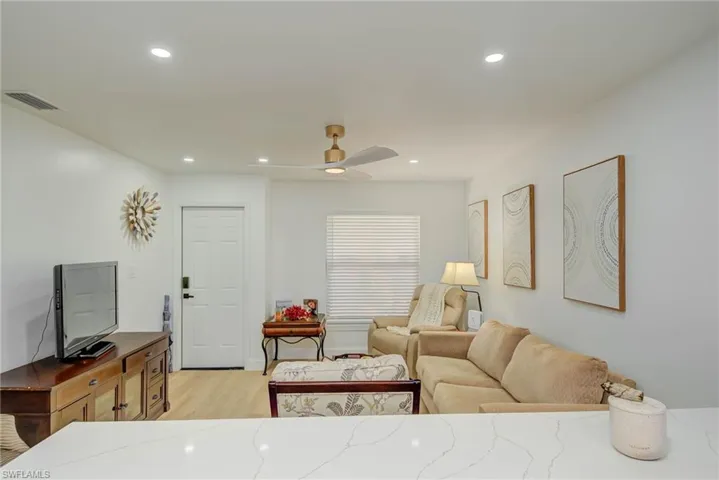 Living area featuring light wood-style flooring, recessed lighting, and ceiling fan
