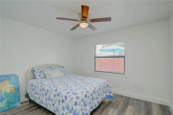 Bedroom with wood finished floors and a ceiling fan