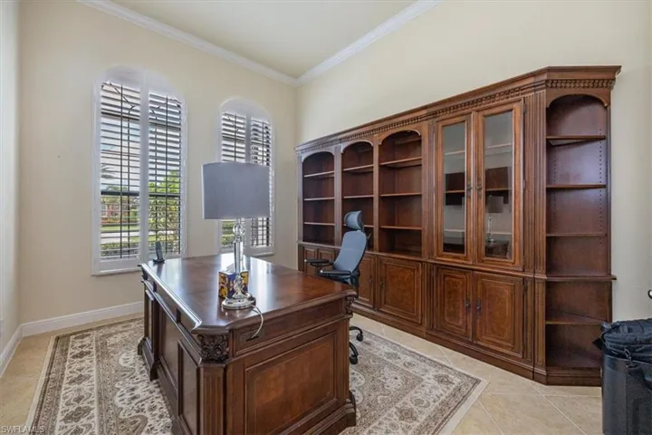 Home office featuring ornamental molding and light tile patterned flooring