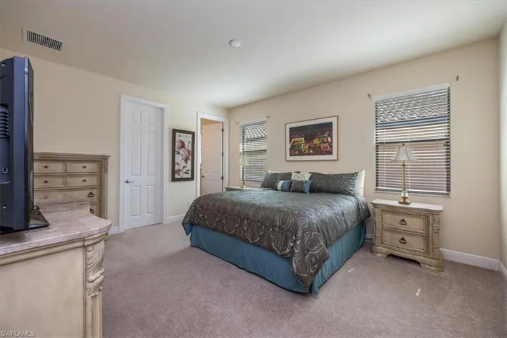 Carpeted bedroom featuring baseboards
