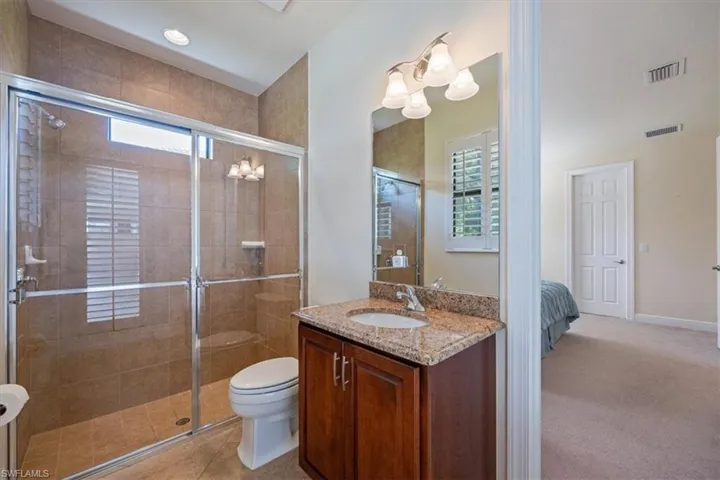Bathroom featuring vanity, a shower stall, and recessed lighting
