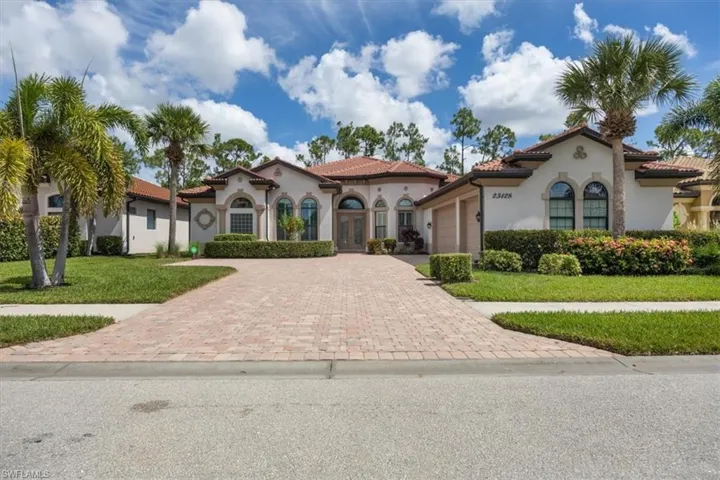 Mediterranean / spanish home featuring french doors, a garage, decorative driveway, and stucco siding