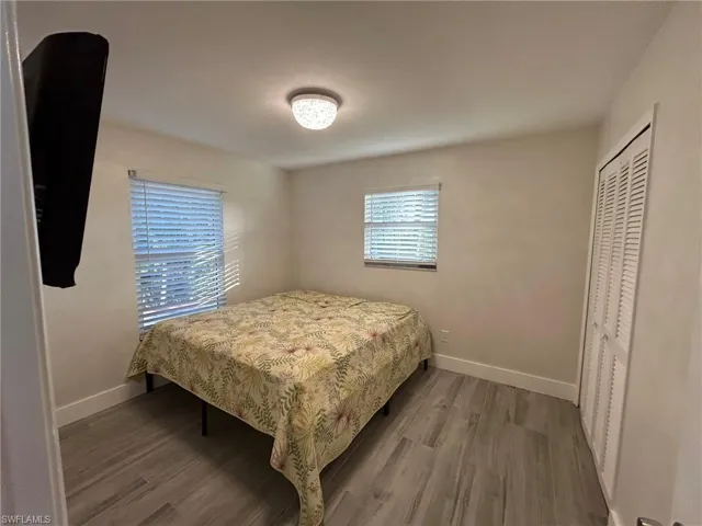 Bedroom with gray tile floors and a closet