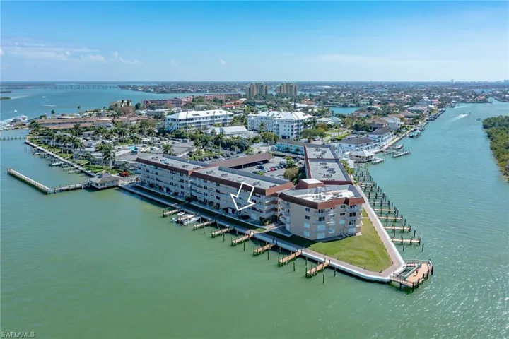 Aerial view of property's location featuring a nearby body of water and nearby urban area