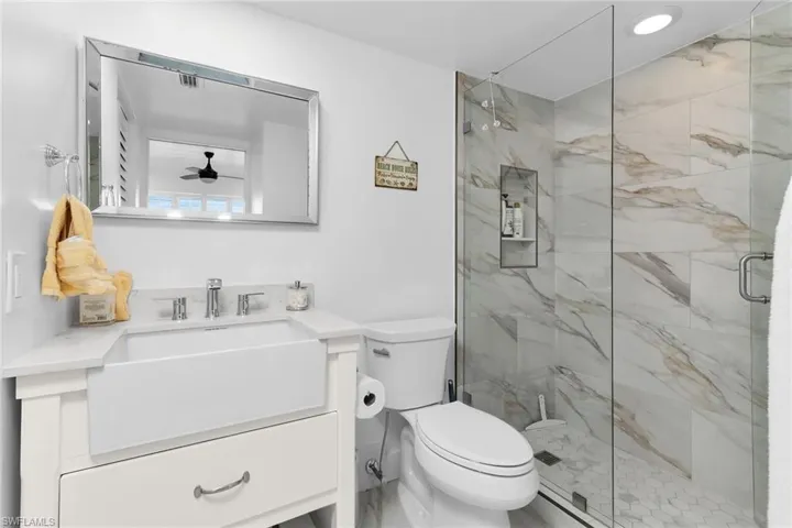 Full primary bathroom featuring vanity and a marble finish shower