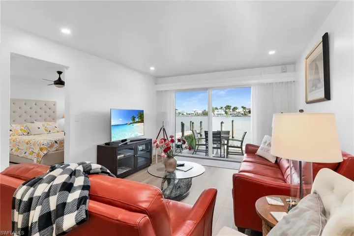 Living room featuring wood finished floors, recessed lighting, and a ceiling fan