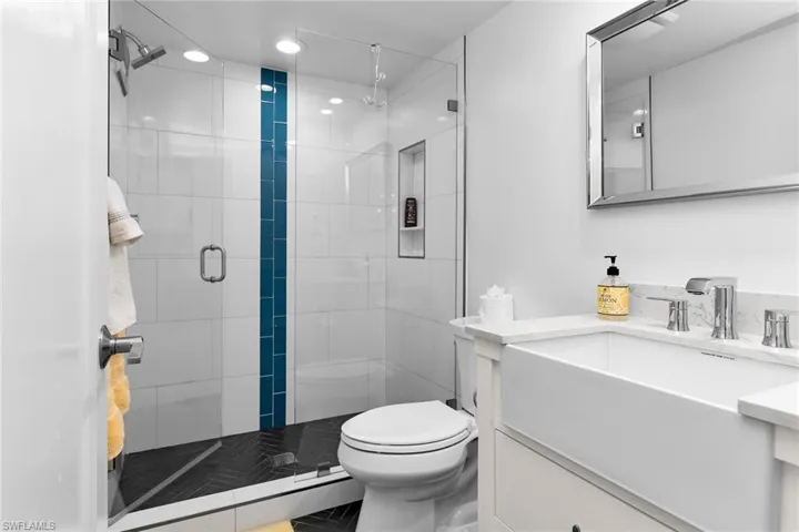 Guest bathroom with vanity, a shower stall, and recessed lighting