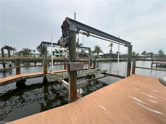Dock featuring boat lift and a water view