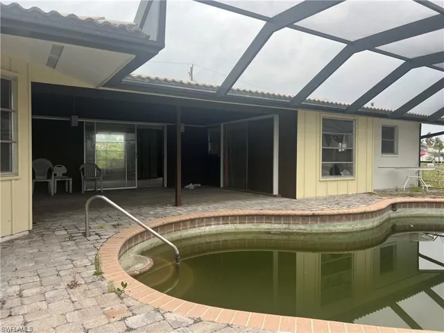 Swimming pool featuring a patio and a lanai