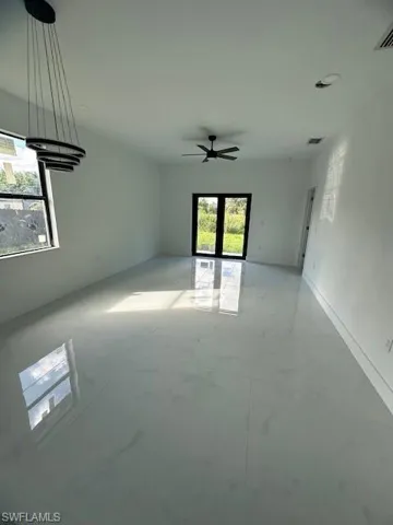 Unfurnished room featuring ceiling fan and baseboards