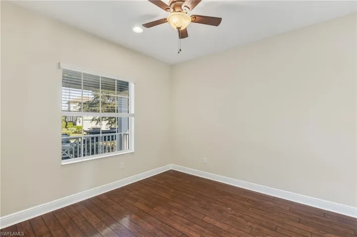 Den/Flex/Office area featuring dark wood-type laminate floors, ceiling fan, and recessed lighting.
