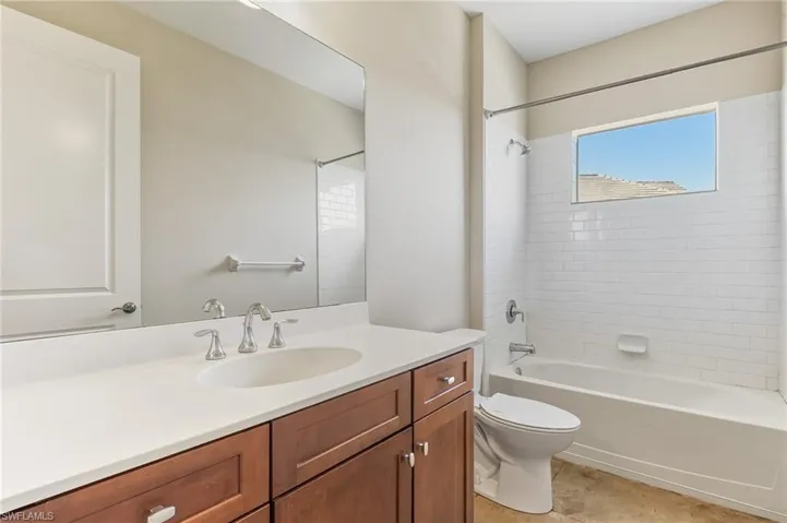 Guest bath with vanity and shower / bathtub combination as well as tile floors.