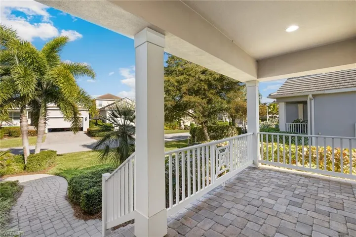 View of front covered porch area and front entry into the home.