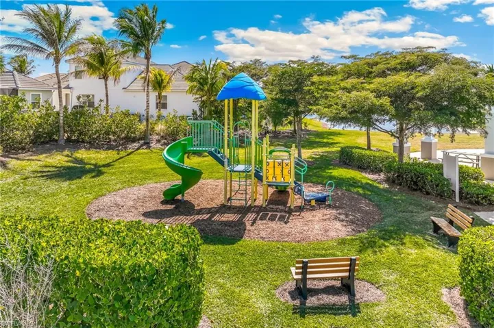 Community play area featuring a landscaped area and benches.