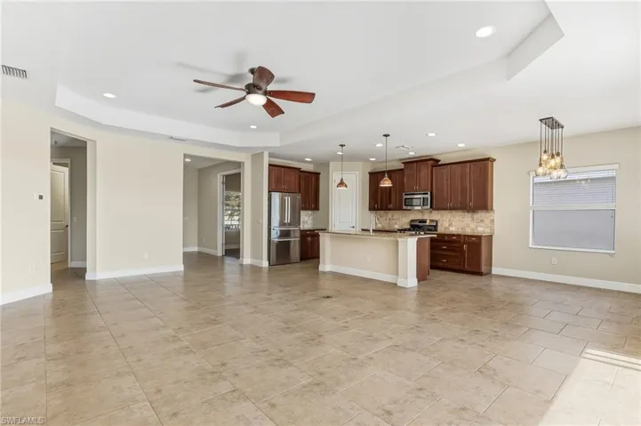 View of the kitchen, dining area and den/flex room from the living room.