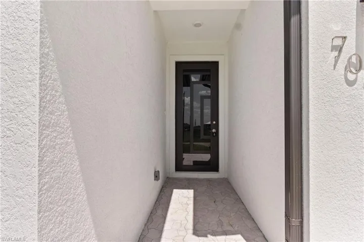 View of exterior entry featuring stucco siding