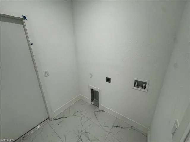 Washroom featuring laundry area, baseboards, marble finish floor, hookup for a washing machine, and electric dryer hookup
