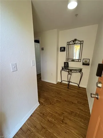 Hall with dark wood-type flooring