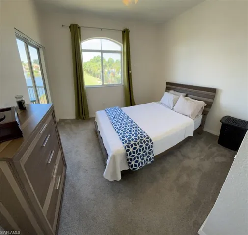Bedroom with dark colored carpet