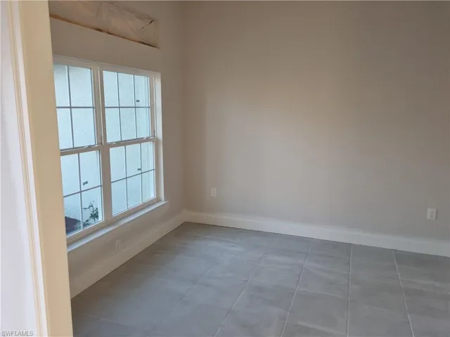 Unfurnished room featuring baseboards
