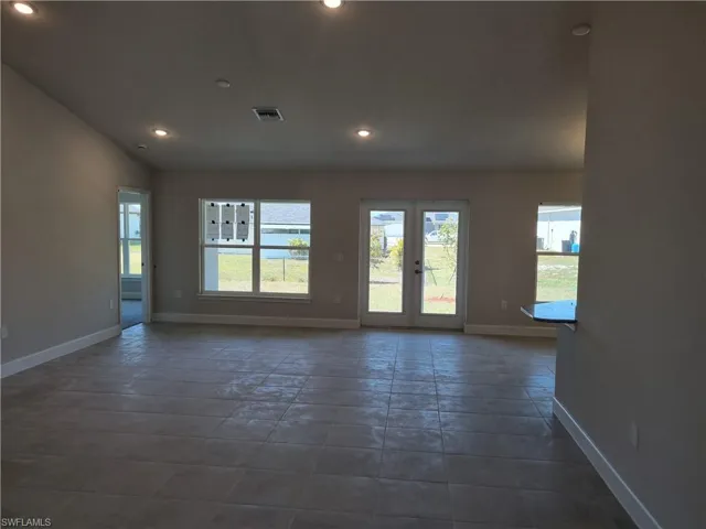 Empty room with recessed lighting, visible vents, baseboards, and french doors