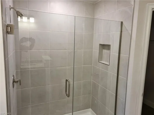 Full bath featuring a shower stall
