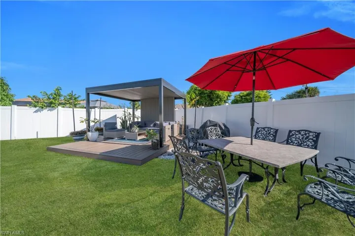Fenced backyard featuring a deck and outdoor lounge area