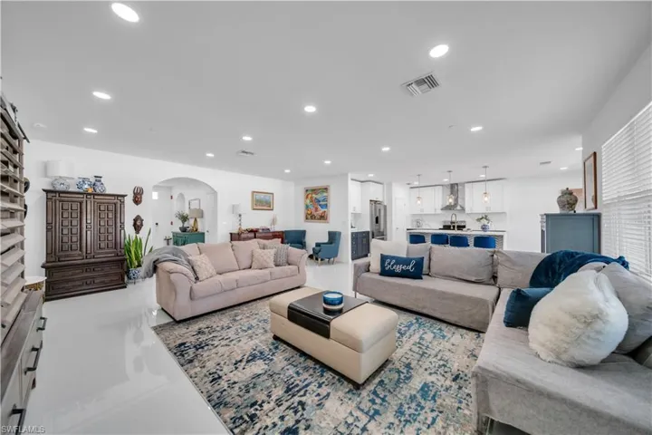 Living room featuring arched walkways and recessed lighting