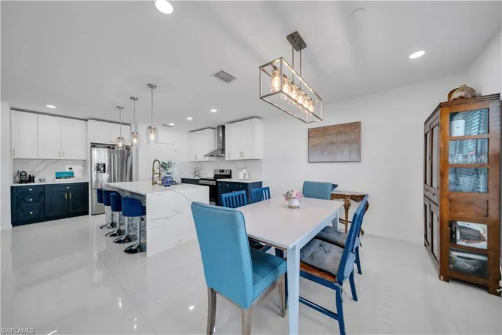 Dining space featuring a chandelier, recessed lighting, and light tile patterned flooring