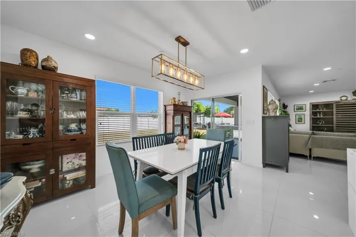 Dining space with recessed lighting, light tile patterned floors, and plenty of natural light