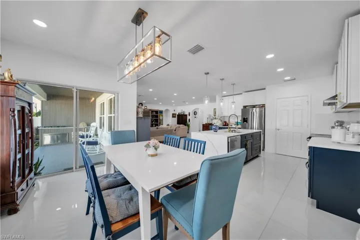 Dining room with recessed lighting and light tile patterned flooring