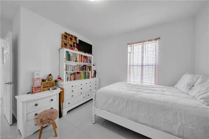 Bedroom with light tile patterned flooring