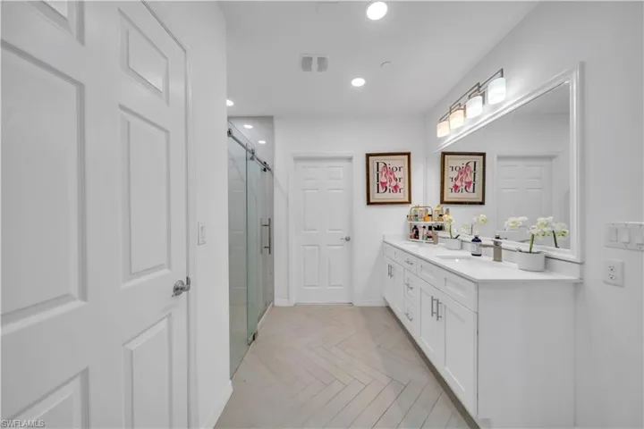 Full bathroom with vanity, recessed lighting, and a stall shower