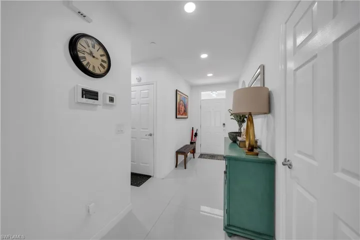 Hall with recessed lighting and light tile patterned floors