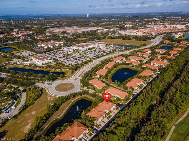Aerial view of property and surrounding area with a large body of water