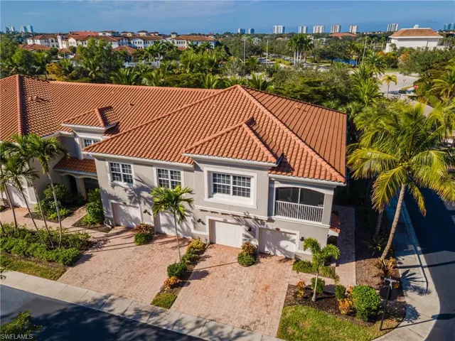 Mediterranean / spanish house featuring an attached garage, stucco siding, decorative driveway, and a tiled roof