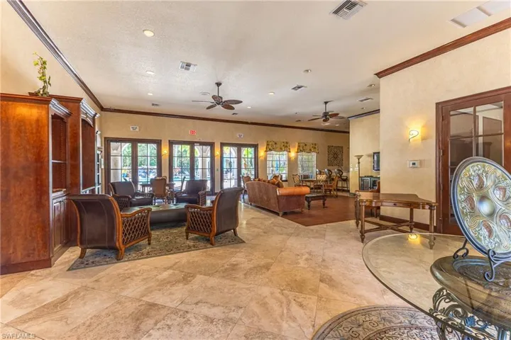 Living area featuring ornamental molding and a ceiling fan