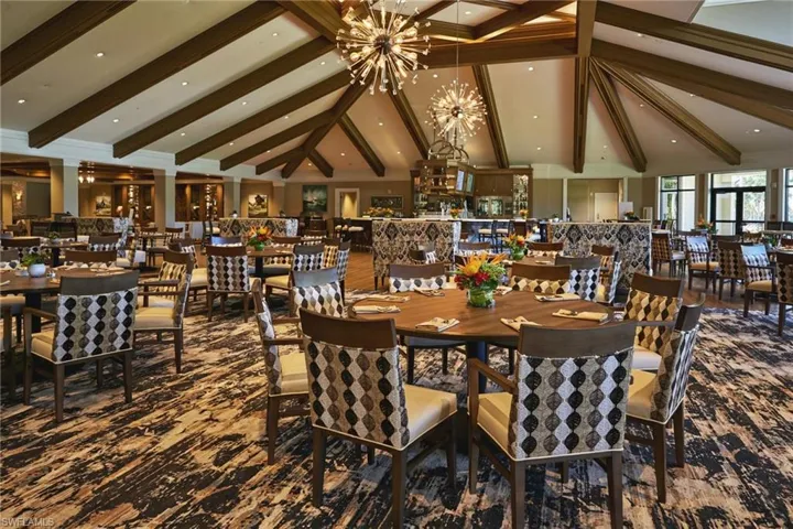 Dining room featuring high vaulted ceiling, a chandelier, and beam ceiling