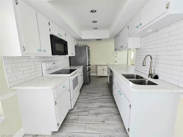Kitchen w/White Cabinetry & Granite Countertops
