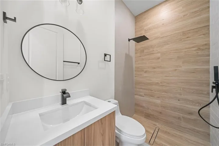 Bathroom featuring vanity and a tile shower