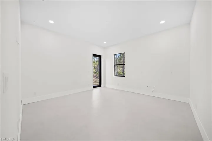Empty room with recessed lighting and baseboards