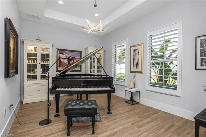 Den/Flex room is located just off the foyer and includes double entry french doors, plantation shutters, and designer lighting.