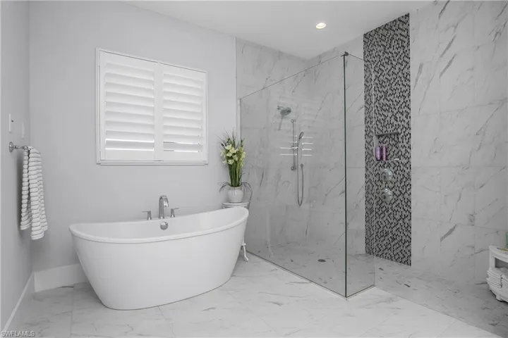 Pamper yourself in the primary/owner bath which includes a large soaking tub and oversized walk-in shower with custom tile work and frameless glass enclosure.